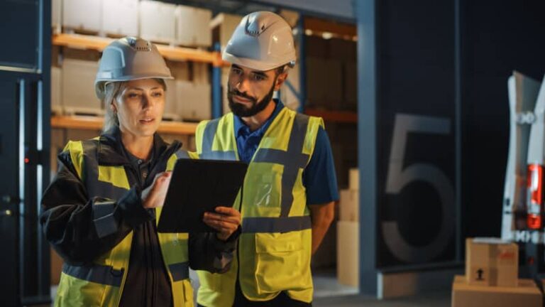 Woman and man looking at a tablet in warehouse