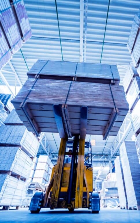 Forklift lifting a load in a warehouse