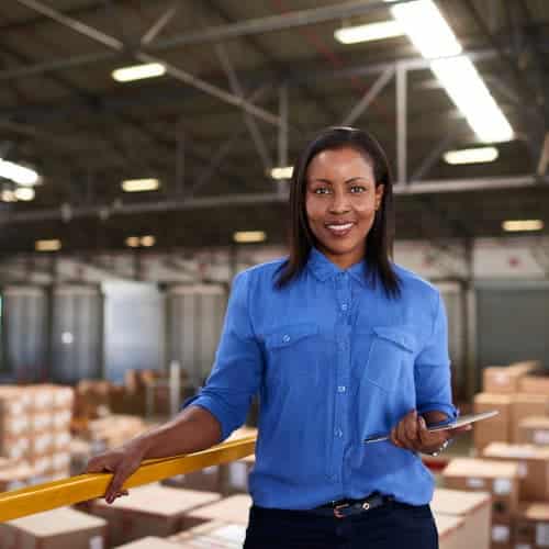 Woman in warehouse with tablet