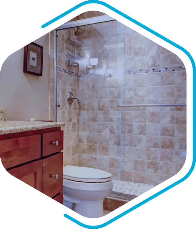 Bathroom with a glass-enclosed shower, beige tiled walls, and seamless integrations like a wooden vanity with granite countertop and a pristine white toilet.